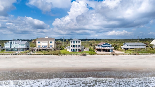 birds eye view of property with a beach view and a water view