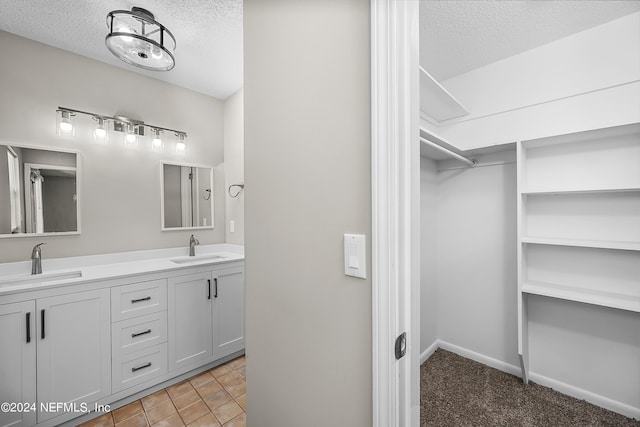 bathroom with a textured ceiling and vanity