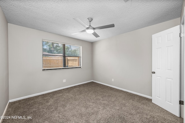 carpeted spare room with ceiling fan and a textured ceiling