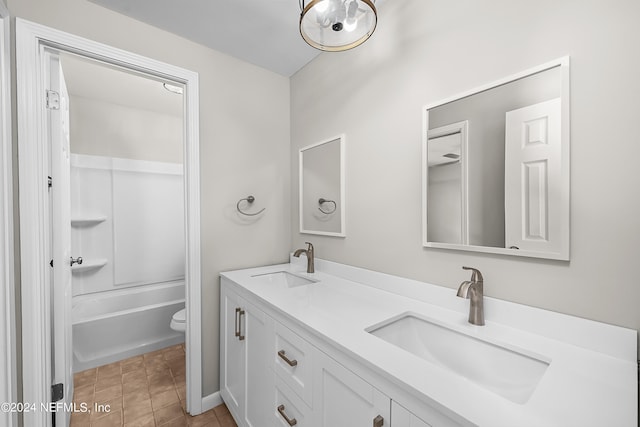 full bathroom featuring tile patterned flooring, toilet, tub / shower combination, and vanity