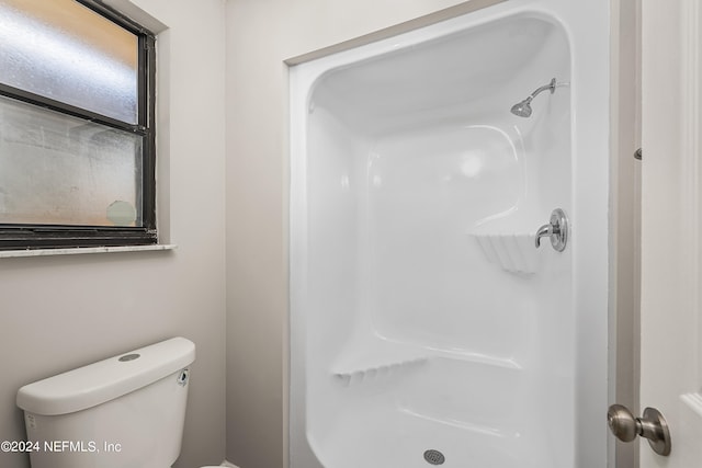 bathroom with toilet and walk in shower