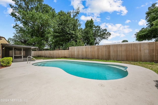 view of pool featuring a patio area and a sunroom