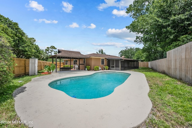 view of swimming pool featuring a patio and a sunroom