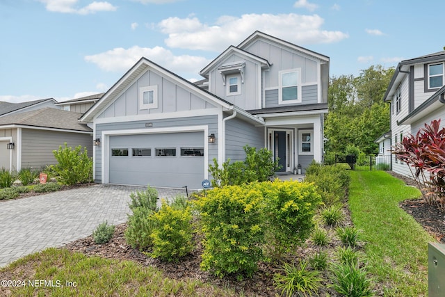 view of front of property featuring a front yard and a garage