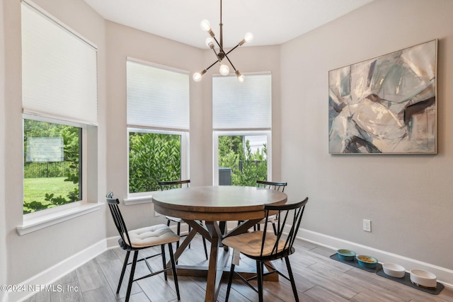 dining space with a chandelier and light hardwood / wood-style floors