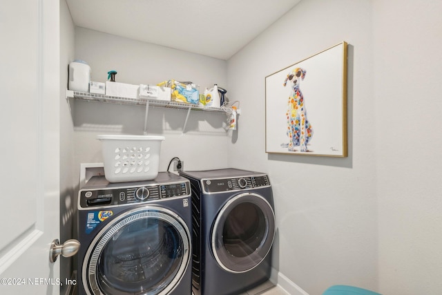 clothes washing area with washing machine and dryer