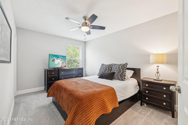 bedroom featuring light carpet and ceiling fan