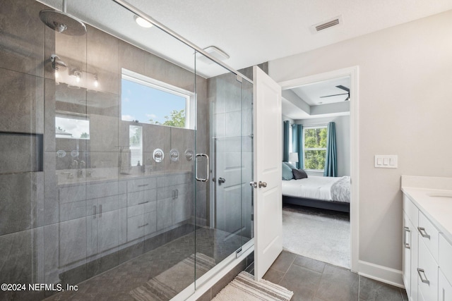 bathroom with vanity, an enclosed shower, and tile patterned flooring