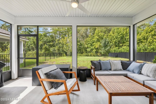 sunroom / solarium featuring ceiling fan