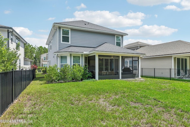 rear view of property with a yard and a sunroom