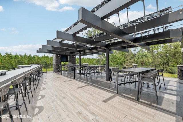 view of patio / terrace featuring an outdoor bar and a pergola