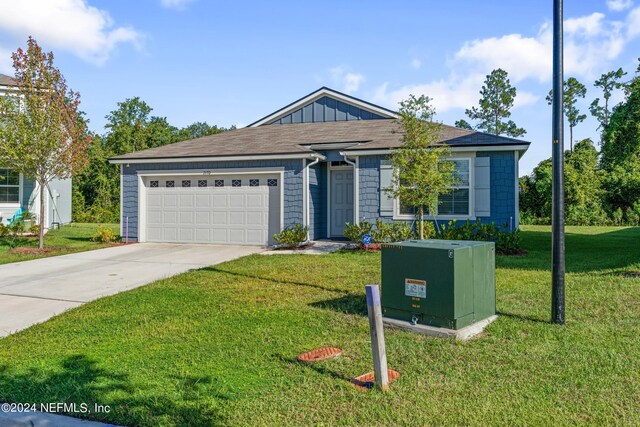 single story home with a front yard and a garage