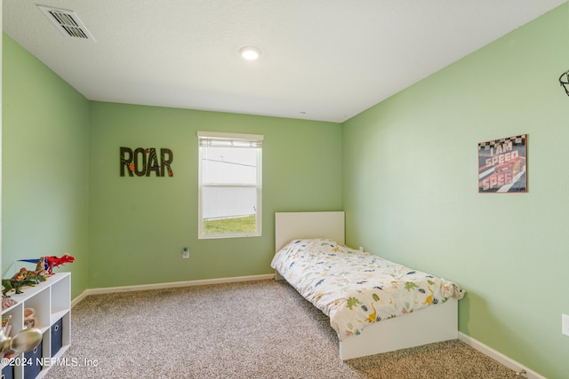 carpeted bedroom featuring visible vents and baseboards