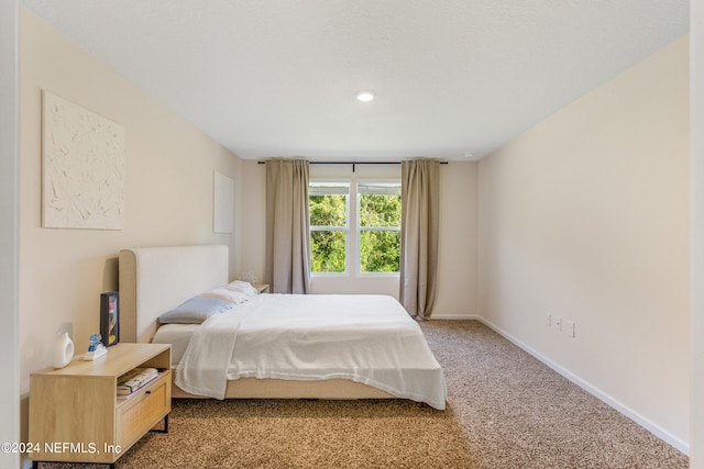 carpeted bedroom featuring baseboards