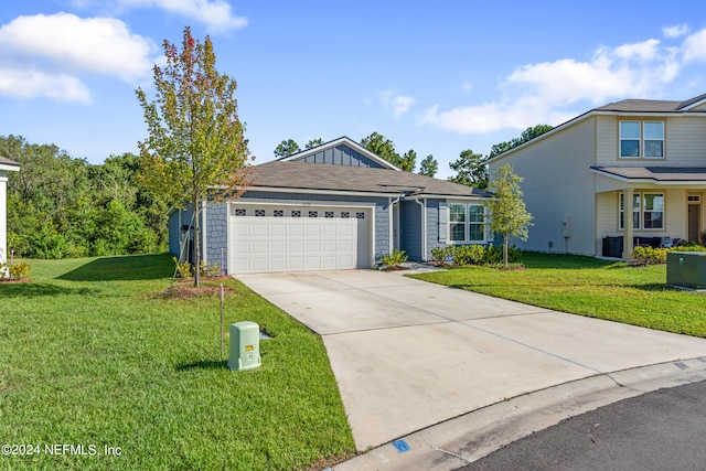 view of front of house with a front yard and a garage