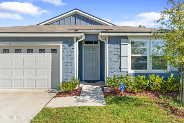 view of front facade with a garage and board and batten siding