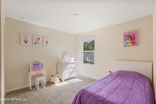 bedroom with carpet flooring and baseboards