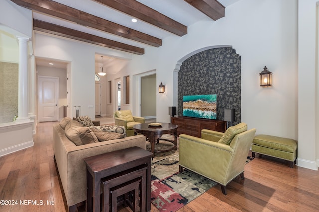 living room with beamed ceiling, hardwood / wood-style floors, and ornate columns