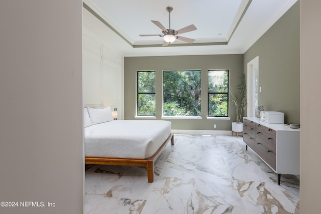 unfurnished bedroom with a raised ceiling, ceiling fan, and ornamental molding