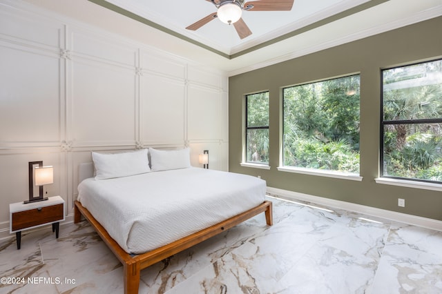 bedroom with ceiling fan and ornamental molding