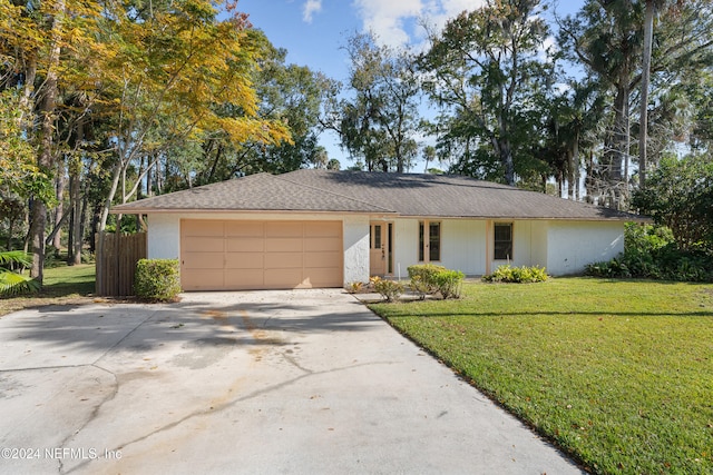 ranch-style home with a front lawn and a garage