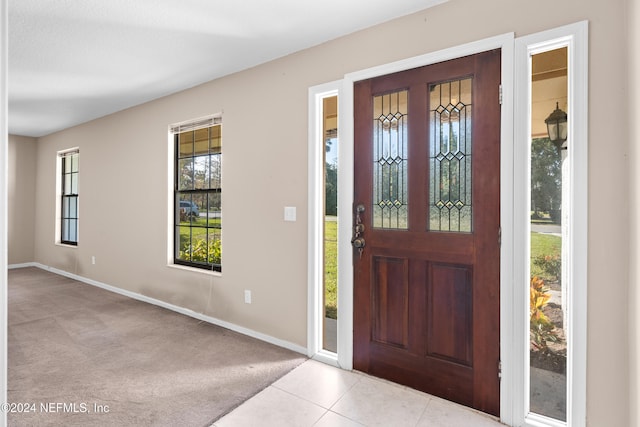 foyer with light colored carpet