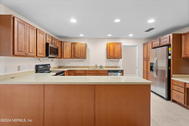 kitchen with kitchen peninsula, sink, light tile patterned flooring, and stainless steel appliances