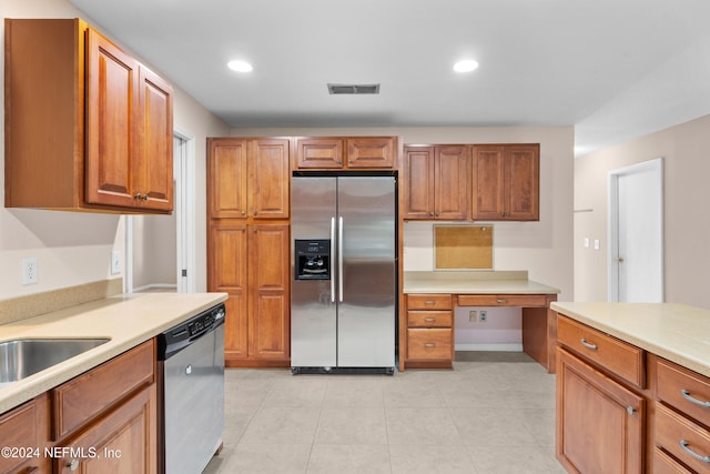 kitchen with light tile patterned floors, sink, and appliances with stainless steel finishes