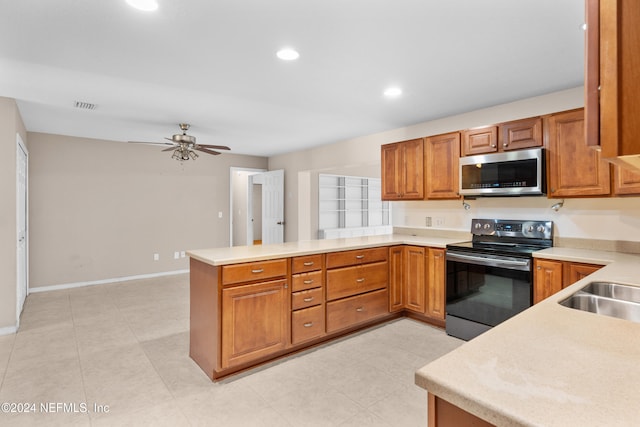 kitchen featuring sink, ceiling fan, light tile patterned floors, appliances with stainless steel finishes, and kitchen peninsula