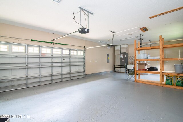 garage with electric panel and a garage door opener