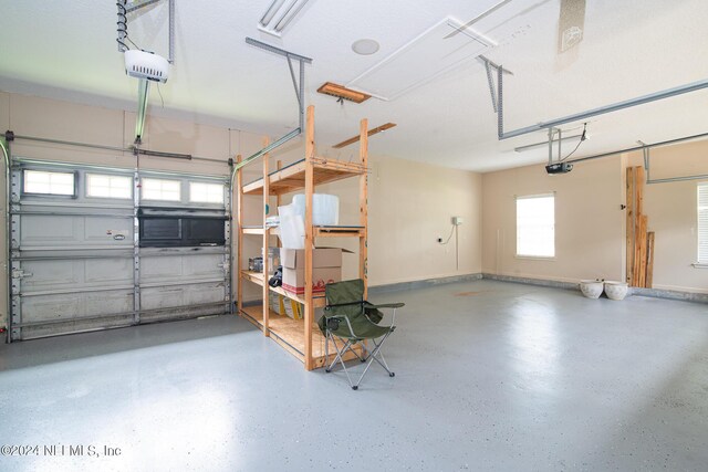 garage with a garage door opener and baseboards