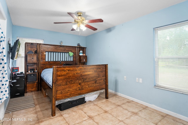 bedroom with ceiling fan and light tile patterned floors