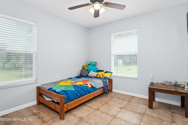 tiled bedroom featuring ceiling fan