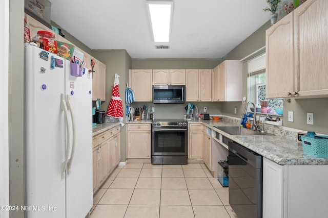 kitchen featuring light tile patterned floors, stainless steel appliances, sink, and light brown cabinets