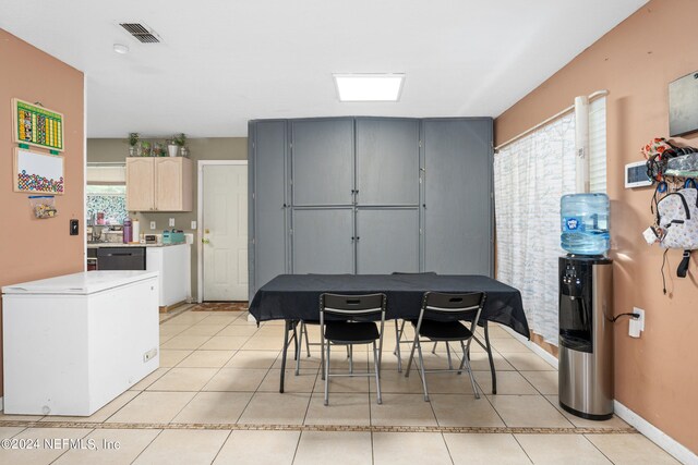 tiled dining space with a wealth of natural light