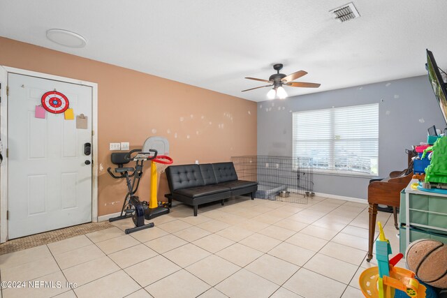 interior space with ceiling fan and light tile patterned flooring