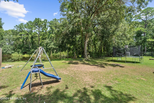 view of playground with a yard and a trampoline