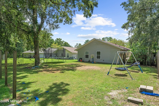 view of yard featuring a trampoline and a playground