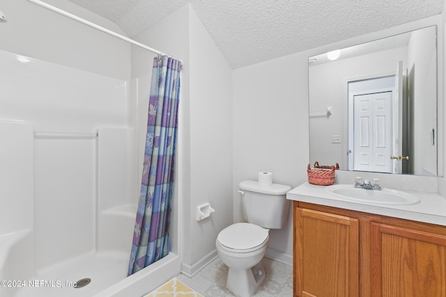 bathroom with vanity, a textured ceiling, toilet, and walk in shower