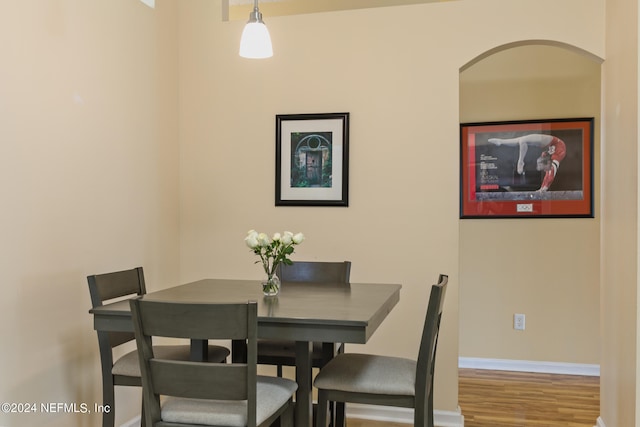 dining space with hardwood / wood-style flooring