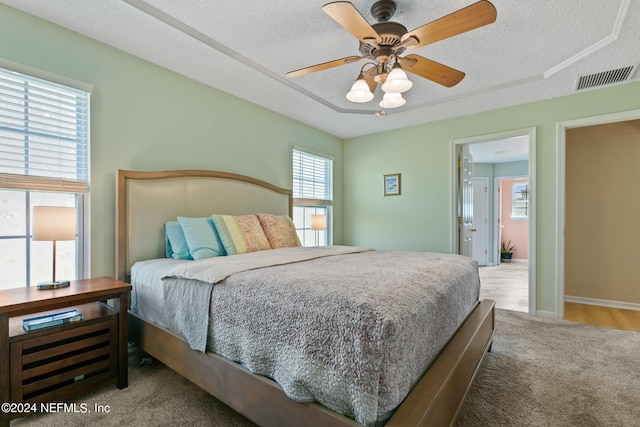 bedroom featuring ceiling fan, a textured ceiling, and wood-type flooring