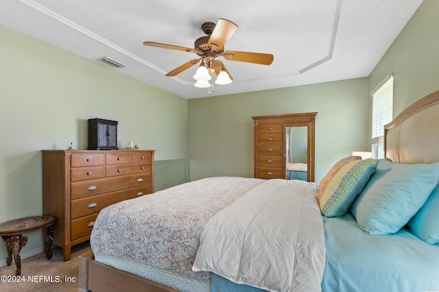 bedroom featuring a textured ceiling, carpet floors, and ceiling fan