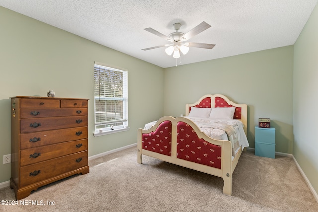 carpeted bedroom with a textured ceiling and ceiling fan