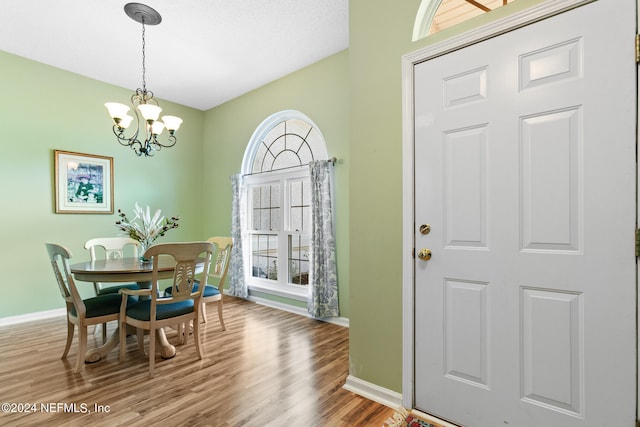 dining space featuring an inviting chandelier and hardwood / wood-style floors