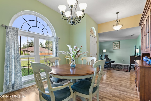 dining room featuring light hardwood / wood-style floors and a chandelier