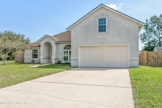 front of property with a front yard and a garage