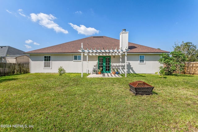 back of property featuring an outdoor fire pit, a patio area, a yard, and a pergola