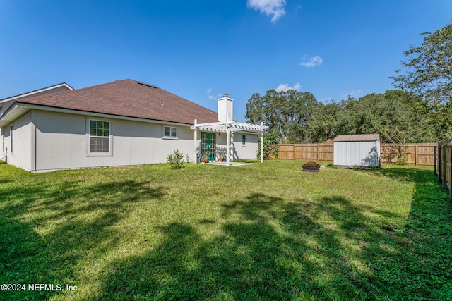 back of property featuring a shed, a yard, and a pergola