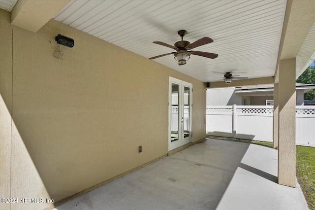 view of patio with ceiling fan, fence, and french doors