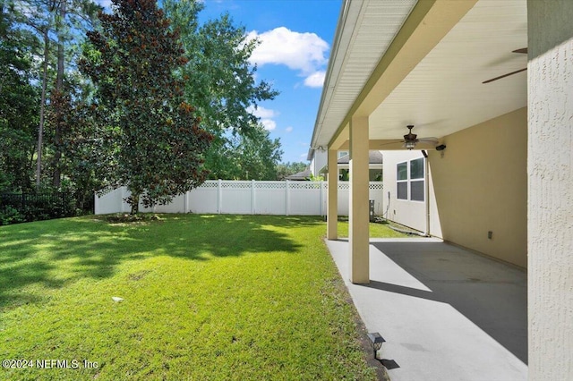 view of yard with ceiling fan, a patio, and a fenced backyard